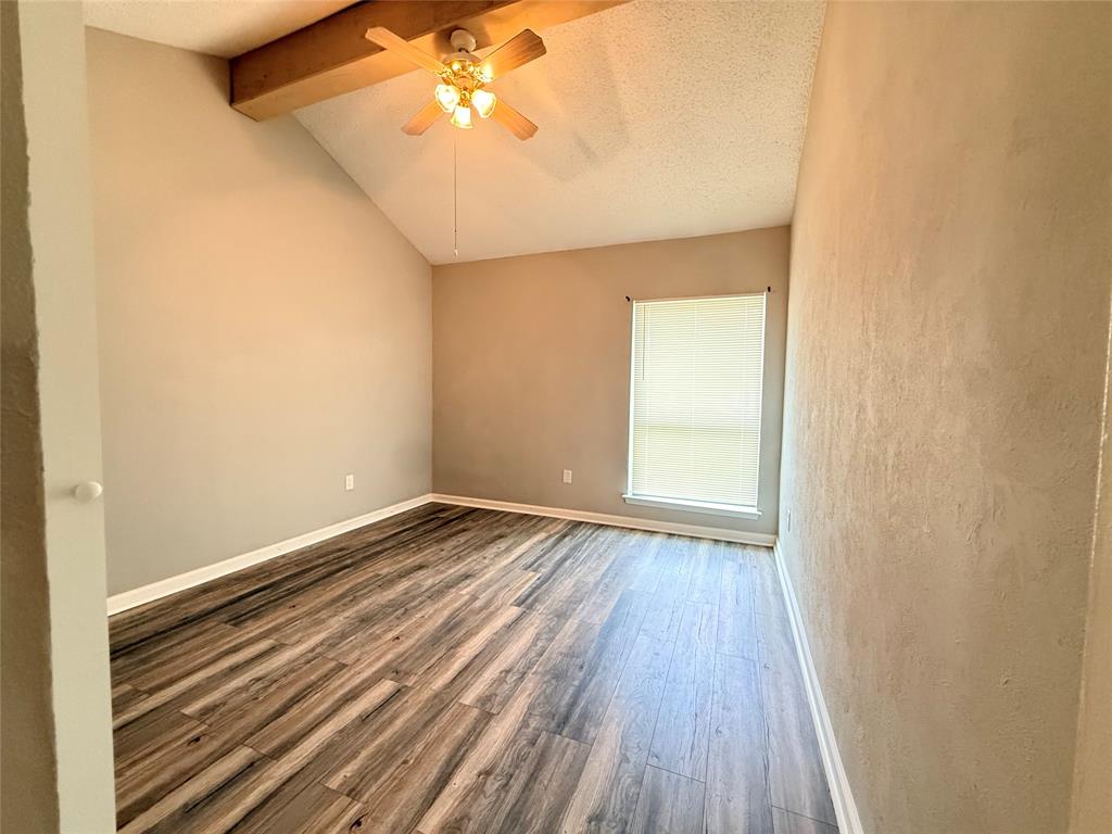 9696 Walnut Street, Unit 813 Dallas, TX 75243 - Photo 13 of 21 a view of an empty room with wooden floor and a window
