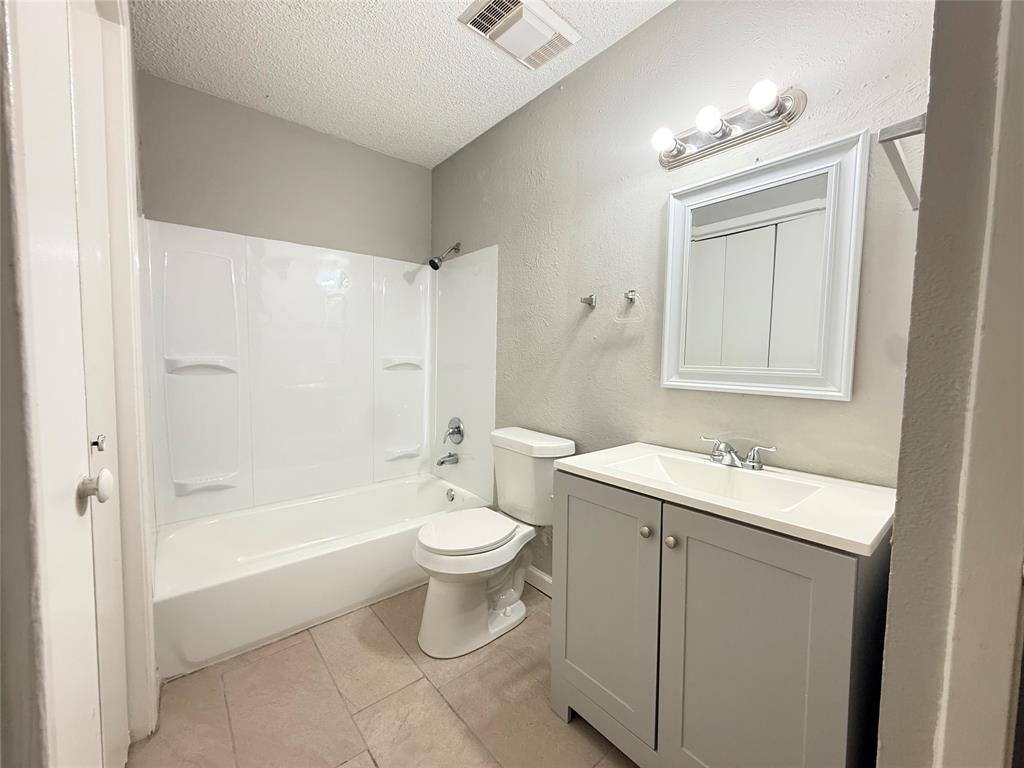 9696 Walnut Street, Unit 813 Dallas, TX 75243 - Photo 15 of 21 a bathroom with a sink toilet a mirror and shower
