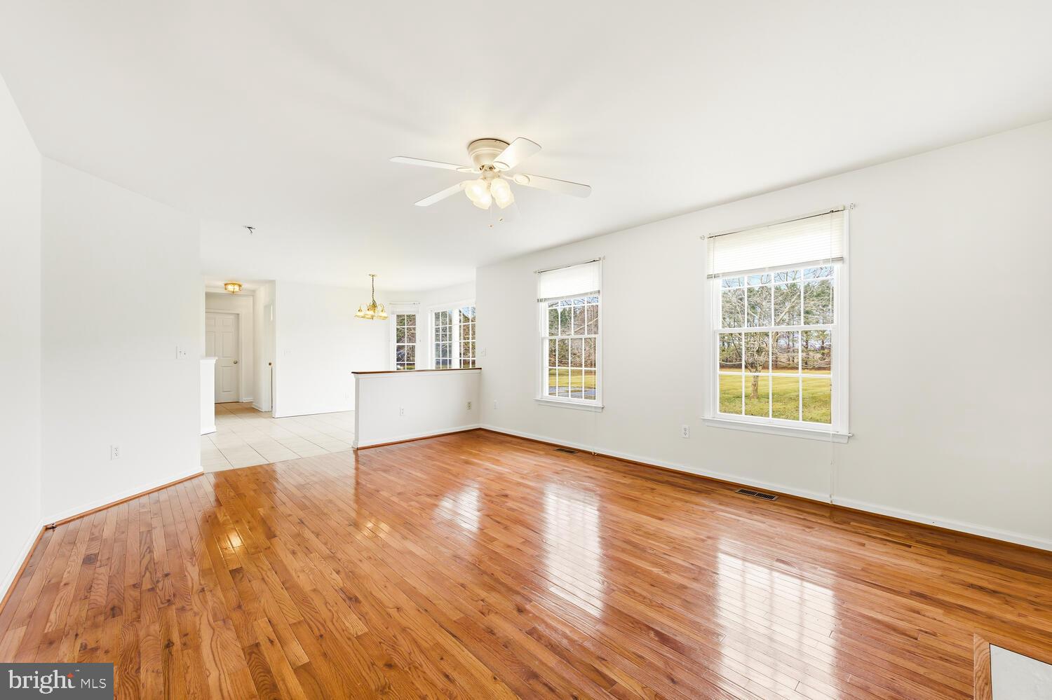 30224 Chestnut Ridge Lane Trappe, MD 21673 - Photo 13 of 46 a view of empty room with wooden floor and fan