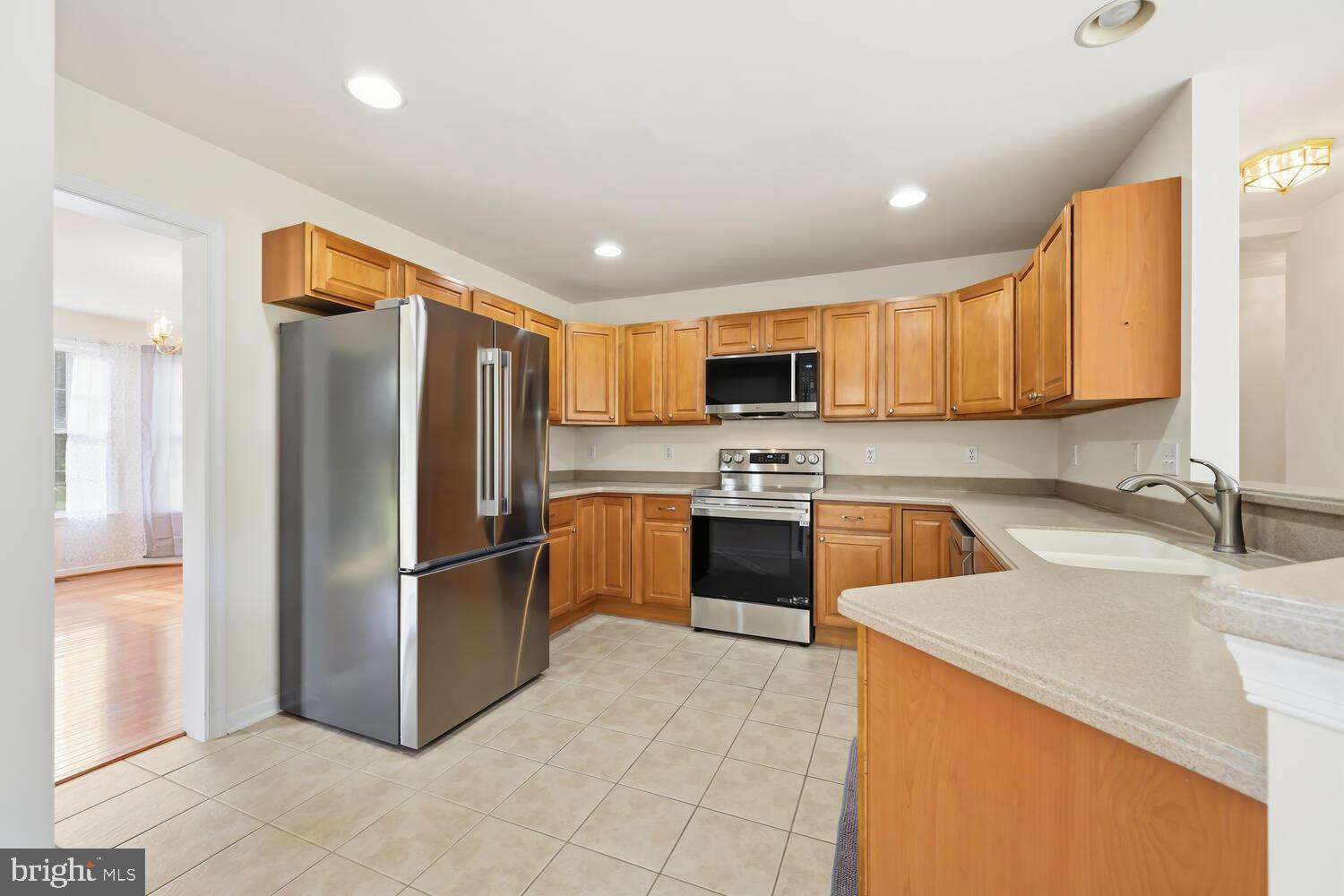 30224 Chestnut Ridge Lane Trappe, MD 21673 - Photo 18 of 46 a kitchen with stainless steel appliances granite countertop a refrigerator sink and stove