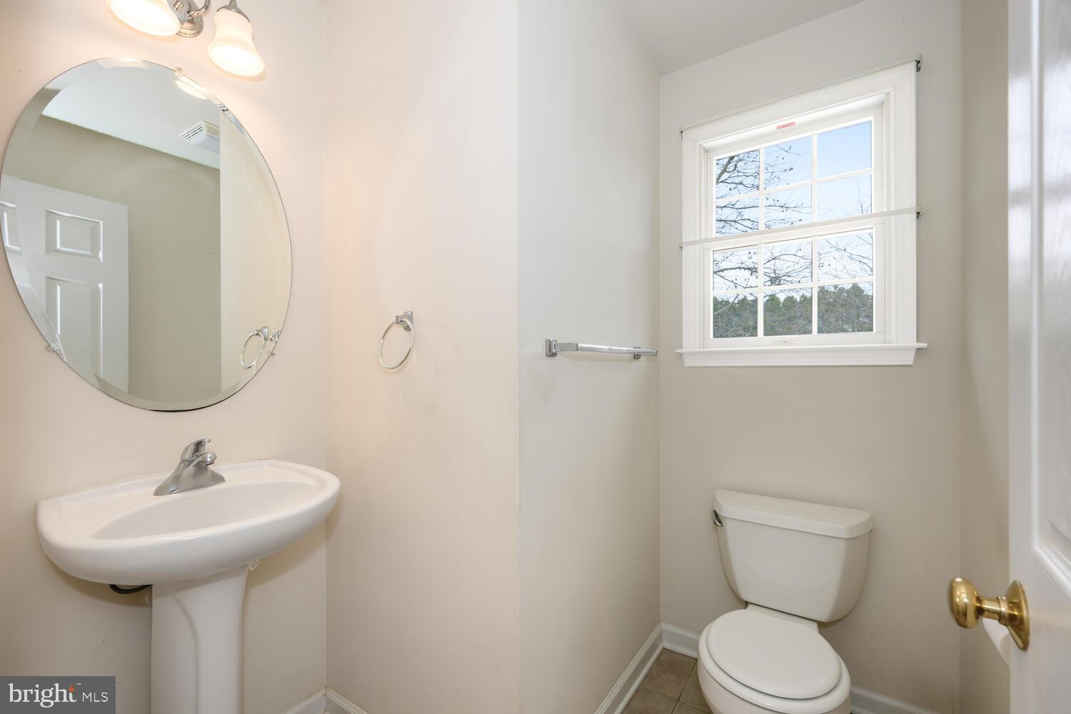 30224 Chestnut Ridge Lane Trappe, MD 21673 - Photo 21 of 46 a bathroom with a toilet sink and mirror