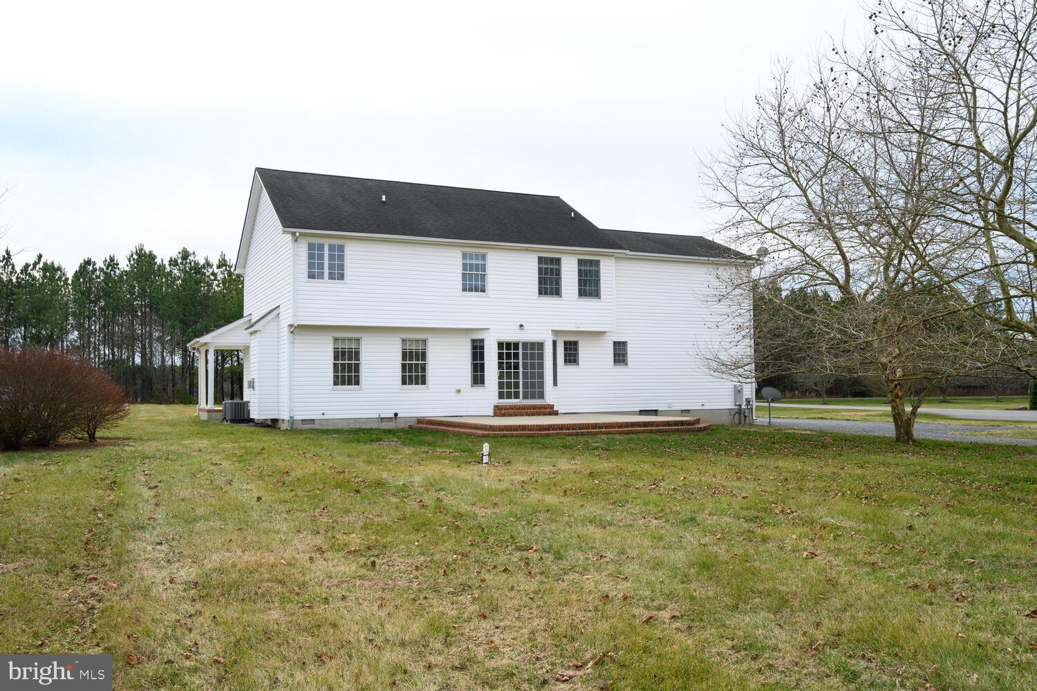 30224 Chestnut Ridge Lane Trappe, MD 21673 - Photo 3 of 46 a white house that has a big yard and a large tree