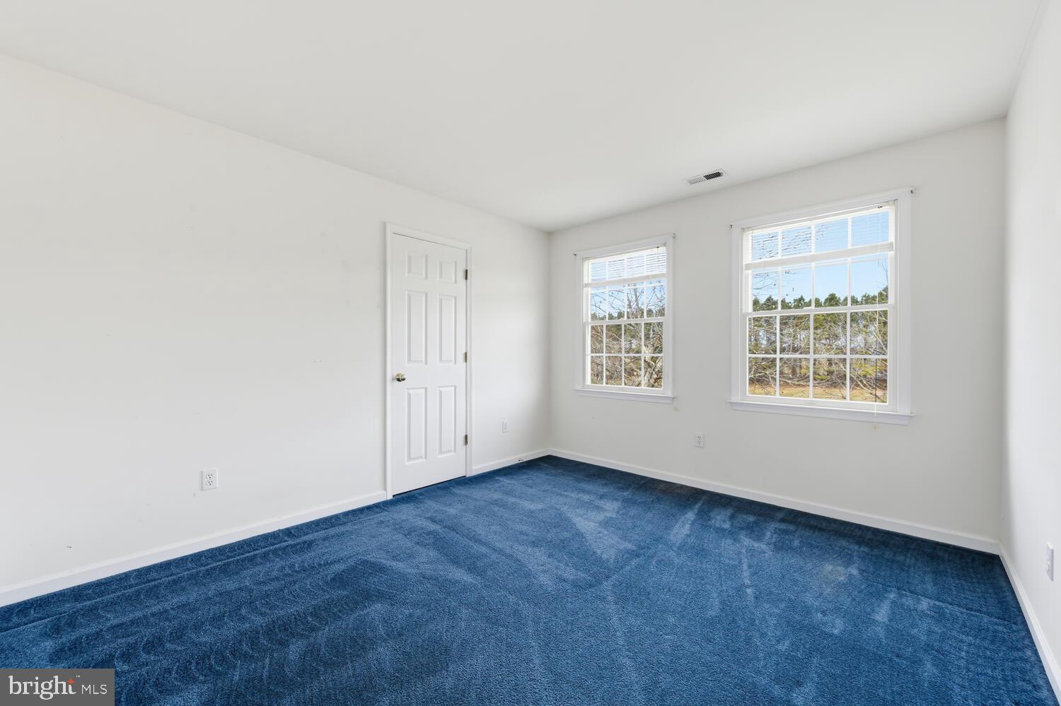 30224 Chestnut Ridge Lane Trappe, MD 21673 - Photo 31 of 46 an empty room with wooden floor and windows