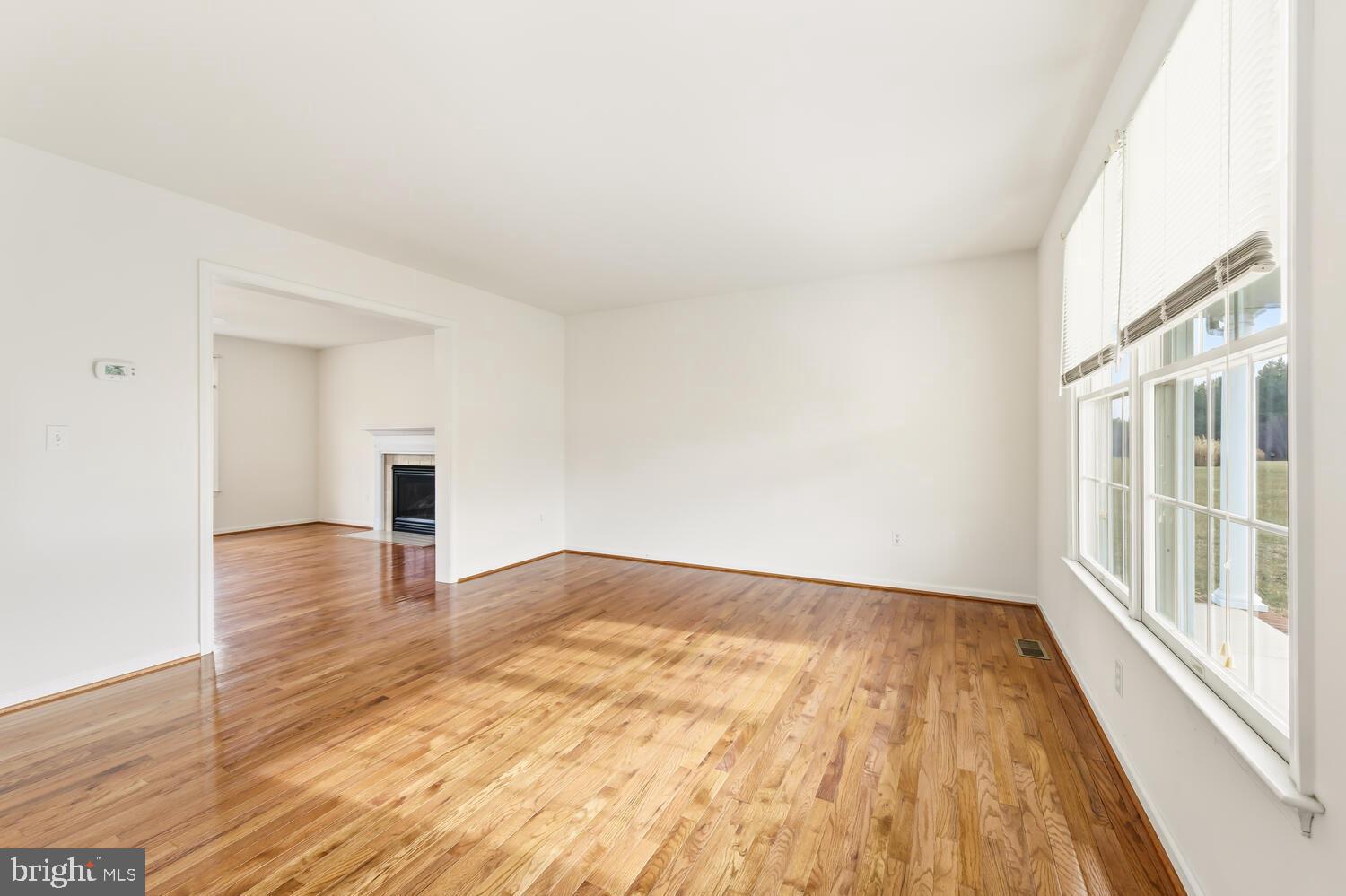 30224 Chestnut Ridge Lane Trappe, MD 21673 - Photo 9 of 46 a view of an empty room with wooden floor and a window