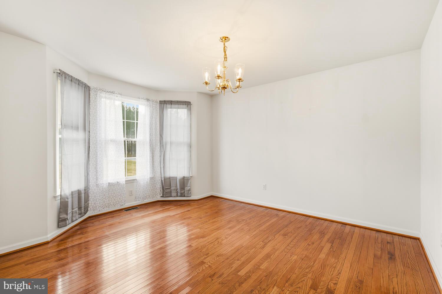 30224 Chestnut Ridge Lane Trappe, MD 21673 - Photo 10 of 46 wooden floor in an empty room with a window