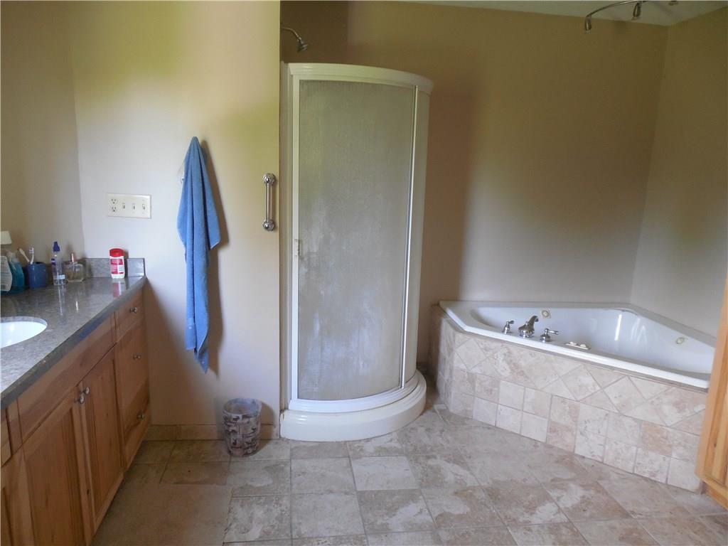 249 West Lake Road Transfer, PA 16154 - Photo 11 of 19 Jacuzzi tub, shower and large vanity with ceramic floor.