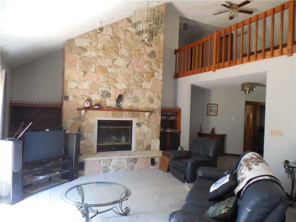 249 West Lake Road Transfer, PA 16154 - Photo 8 of 19 The living room has a wonderful stone fireplace, new carpet and French doors to the a new deck.