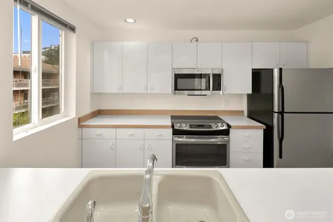 a kitchen with a refrigerator stove and microwave