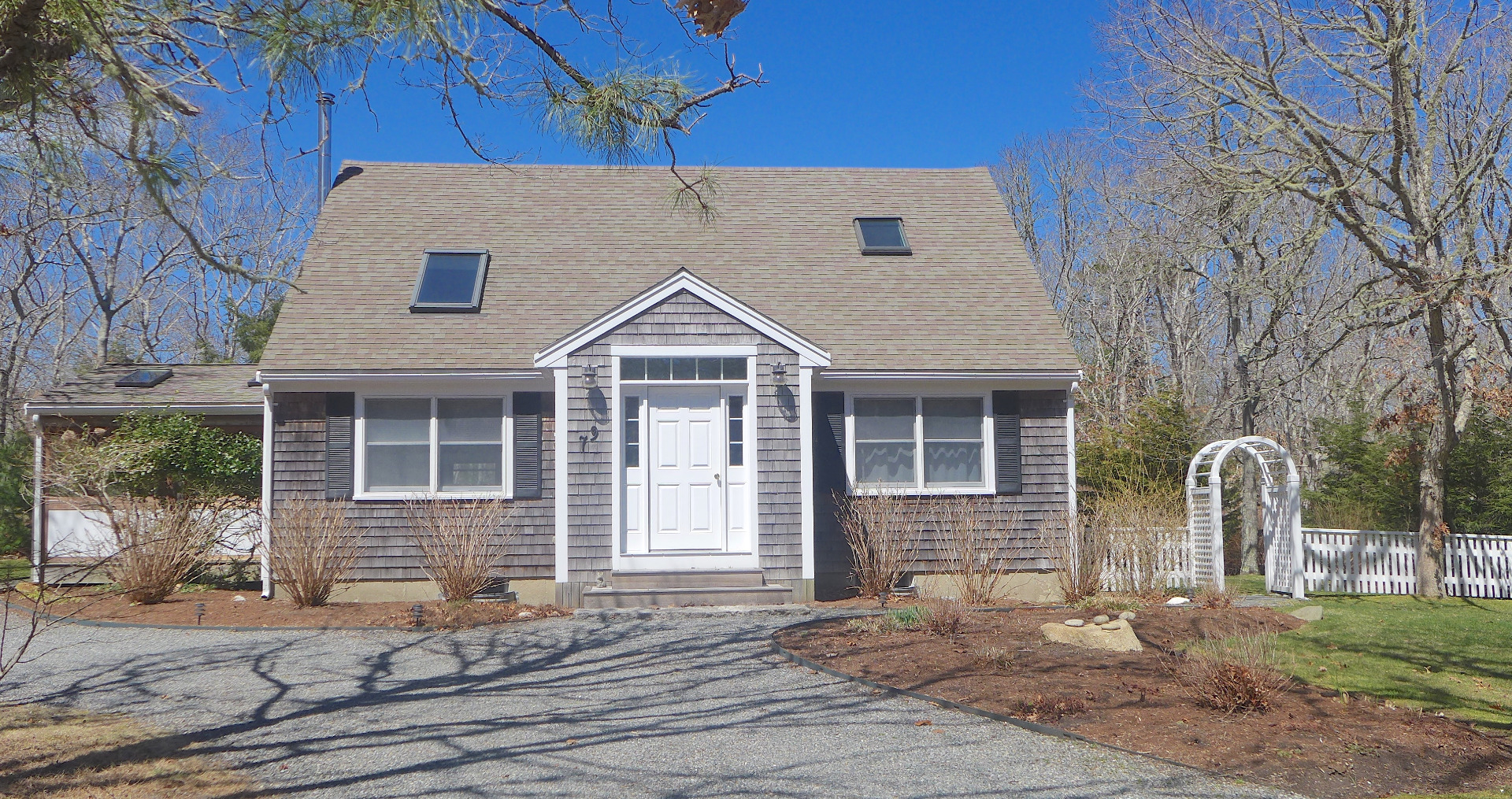 79 Old Purchase Road Edgartown, MA 02539 - Photo 2 of 14 a front view of a house with a yard