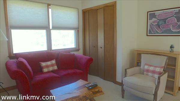 79 Old Purchase Road Edgartown, MA 02539 - Photo 11 of 14 a blue couch sitting in a living room next to a window