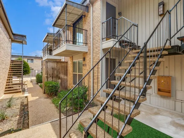 a view of building with yard and staircase