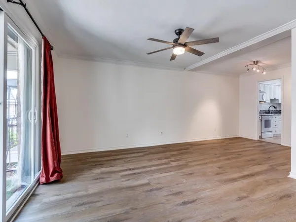 a view of a livingroom with a ceiling fan and window
