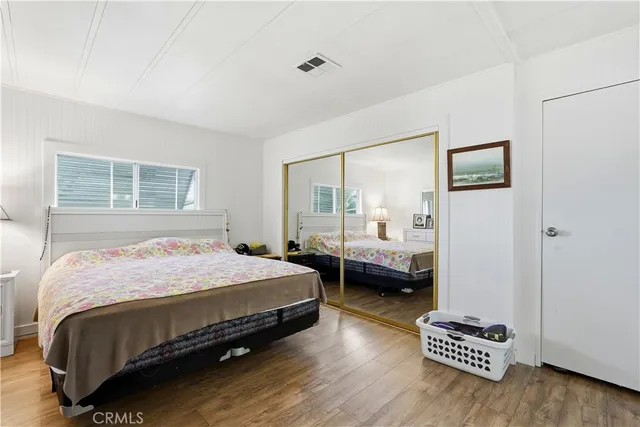 a bedroom with bed and a large window