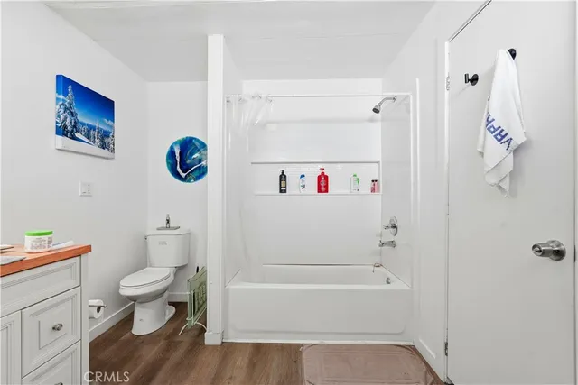a bathroom with a sink a toilet and a shower curtain