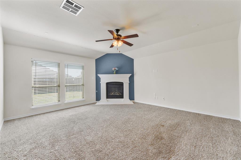 3031 Lily Lane Forney, TX 75126 - Photo 13 of 28 an empty room with windows and fireplace