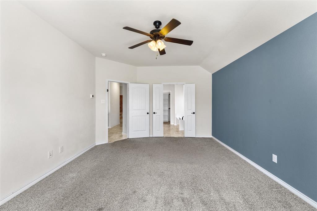 3031 Lily Lane Forney, TX 75126 - Photo 16 of 28 a view of an empty room with a ceiling fan