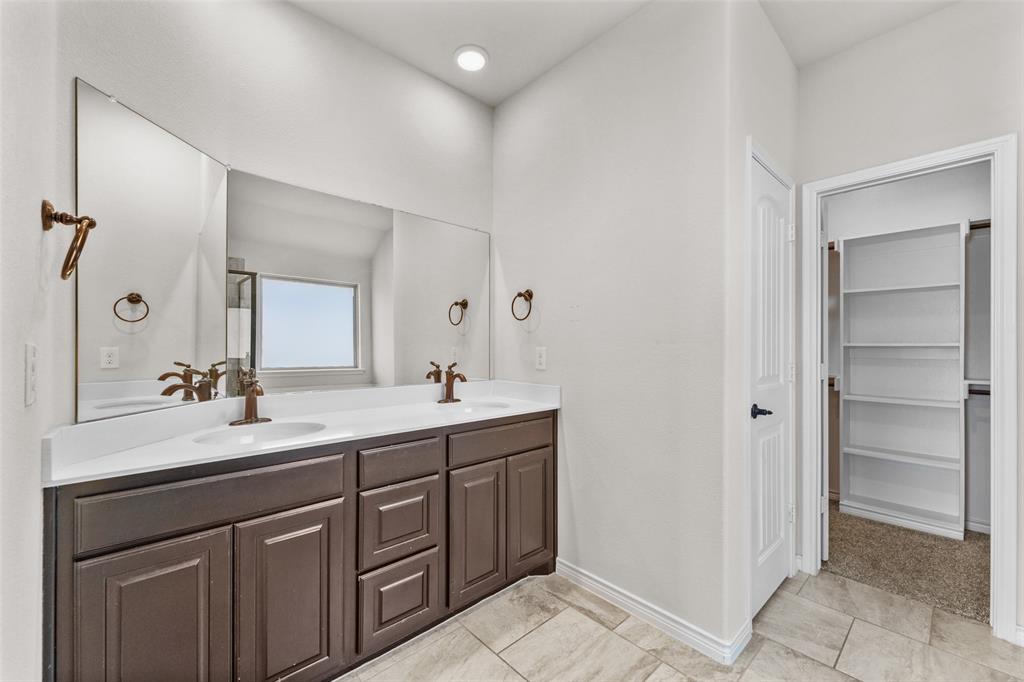 3031 Lily Lane Forney, TX 75126 - Photo 17 of 28 a bathroom with a double vanity sink and mirror