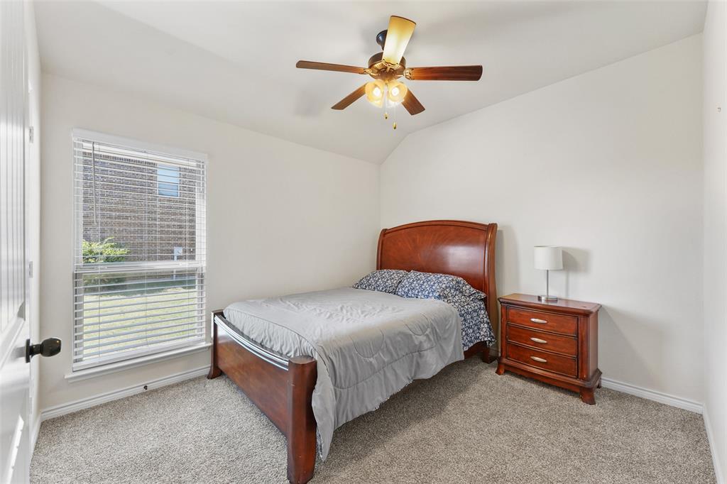 3031 Lily Lane Forney, TX 75126 - Photo 18 of 28 a bedroom with a bed and a ceiling fan
