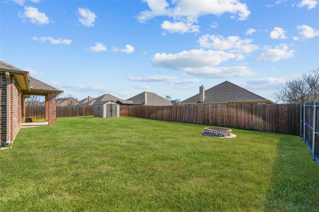 3031 Lily Lane Forney, TX 75126 - Photo 22 of 28 a view of a backyard with table and chairs with wooden fence