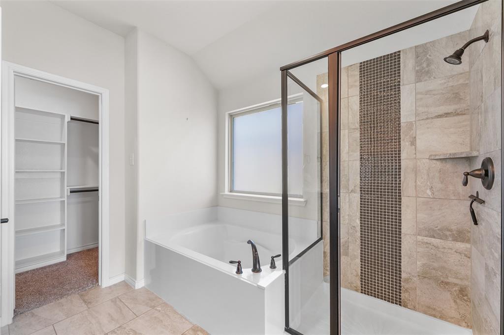 3031 Lily Lane Forney, TX 75126 - Photo 4 of 28 a bathroom with a bathtub and a shower