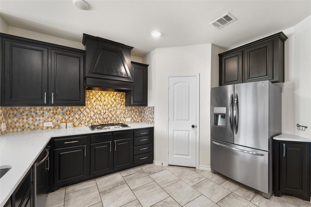 3031 Lily Lane Forney, TX 75126 - Photo 9 of 28 a kitchen with stainless steel appliances granite countertop a refrigerator and a stove top oven
