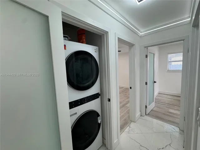 a view of a hallway with washer and dryer