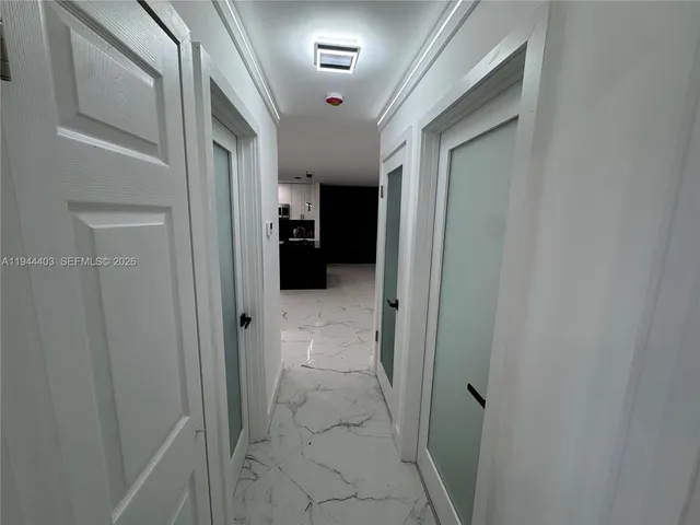 an empty room with closet and a ceiling fan