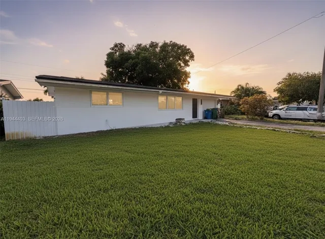 a backyard of a house with lots of green space and lake view