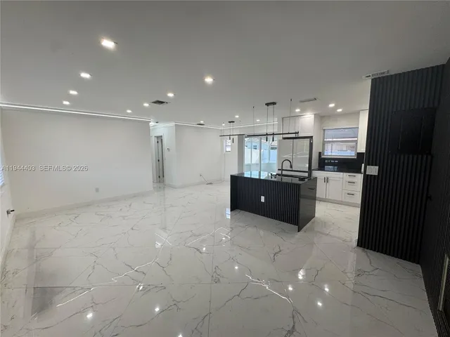 a large bathroom with a sink and a large mirror
