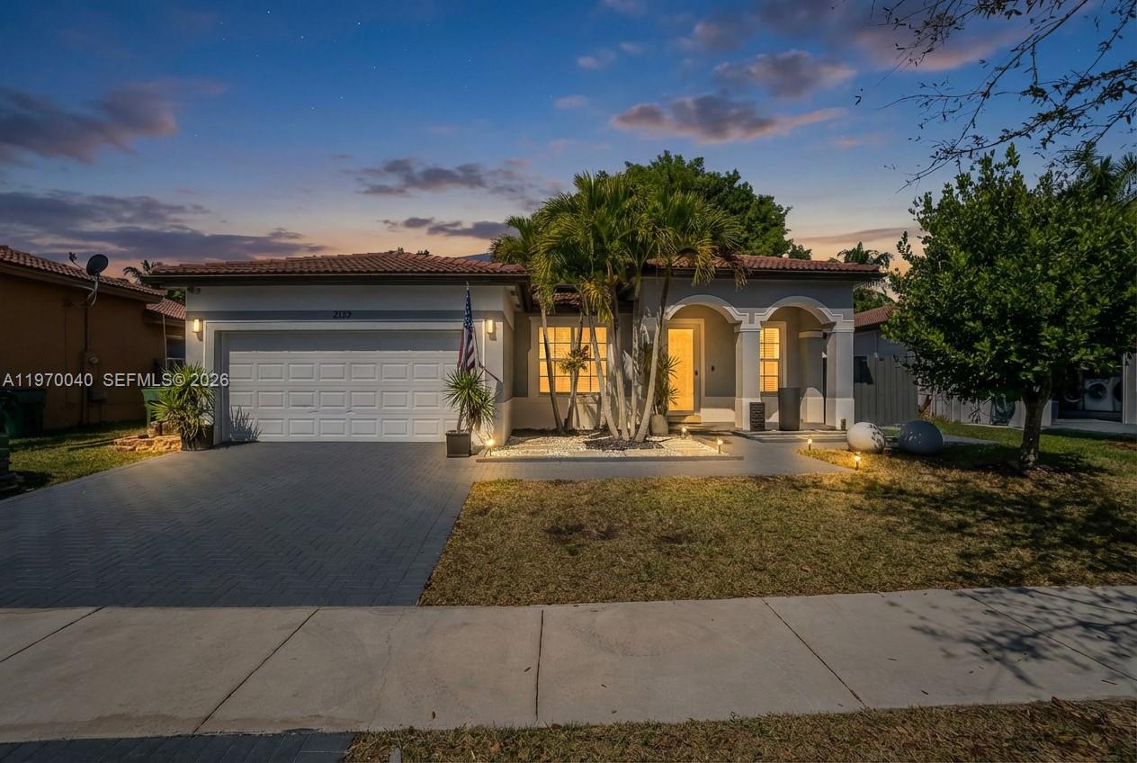 2132 Northeast 38th Road Homestead, FL 33033 - Photo 1 of 48 front view of house with a yard