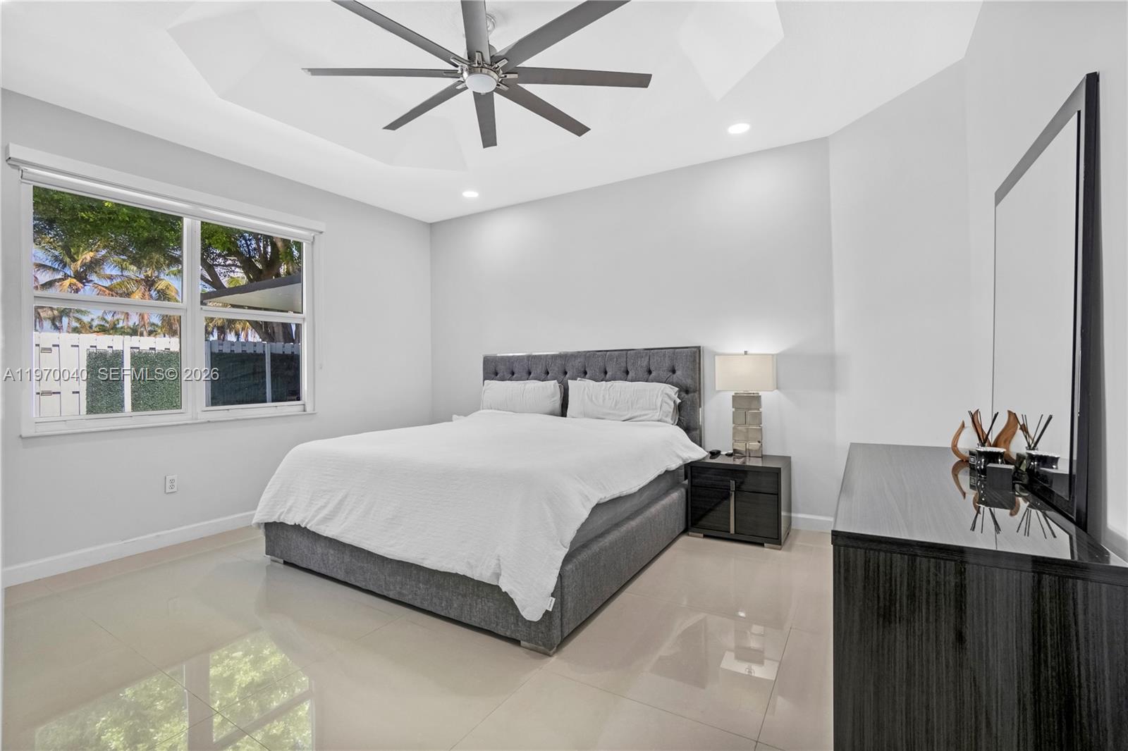 2132 Northeast 38th Road Homestead, FL 33033 - Photo 11 of 48 a bedroom with a bed and dresser with mirror