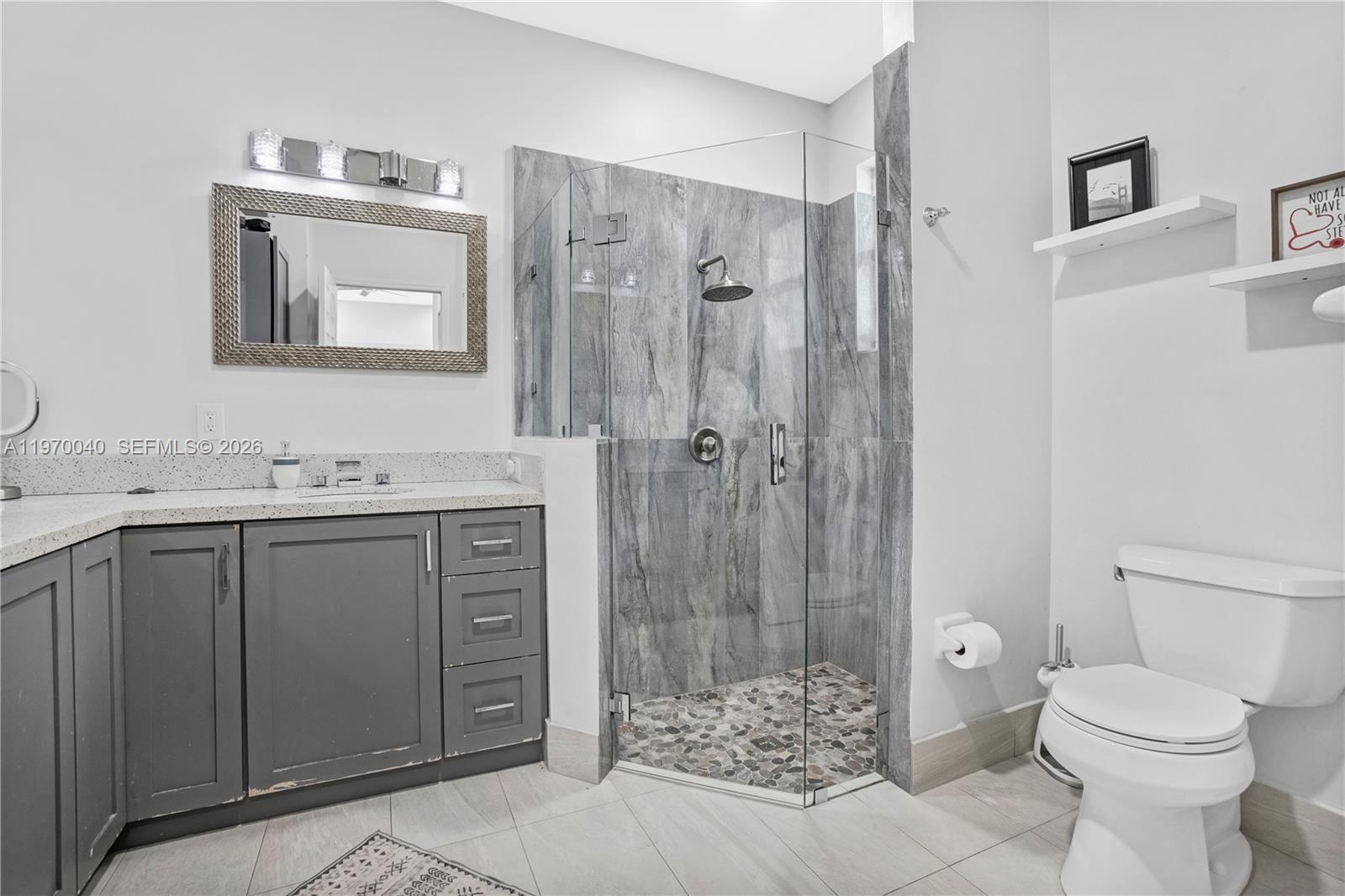 2132 Northeast 38th Road Homestead, FL 33033 - Photo 14 of 48 a bathroom with a granite countertop sink toilet and shower