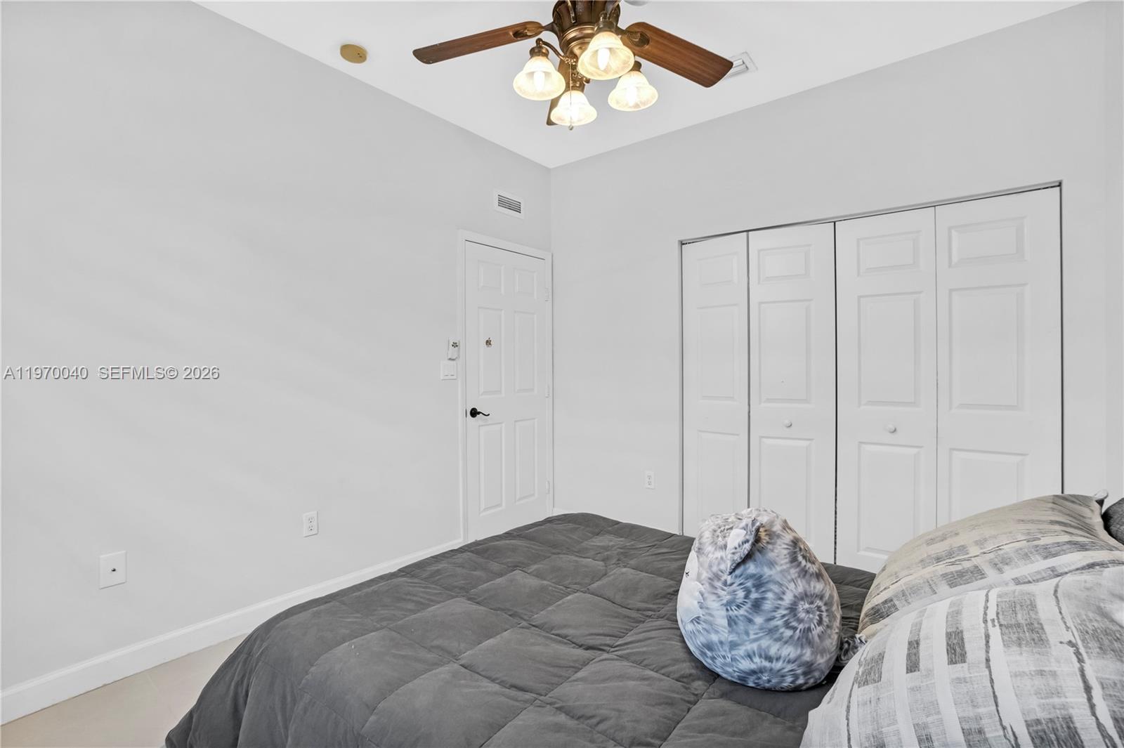 2132 Northeast 38th Road Homestead, FL 33033 - Photo 17 of 48 a bedroom with bed and a window