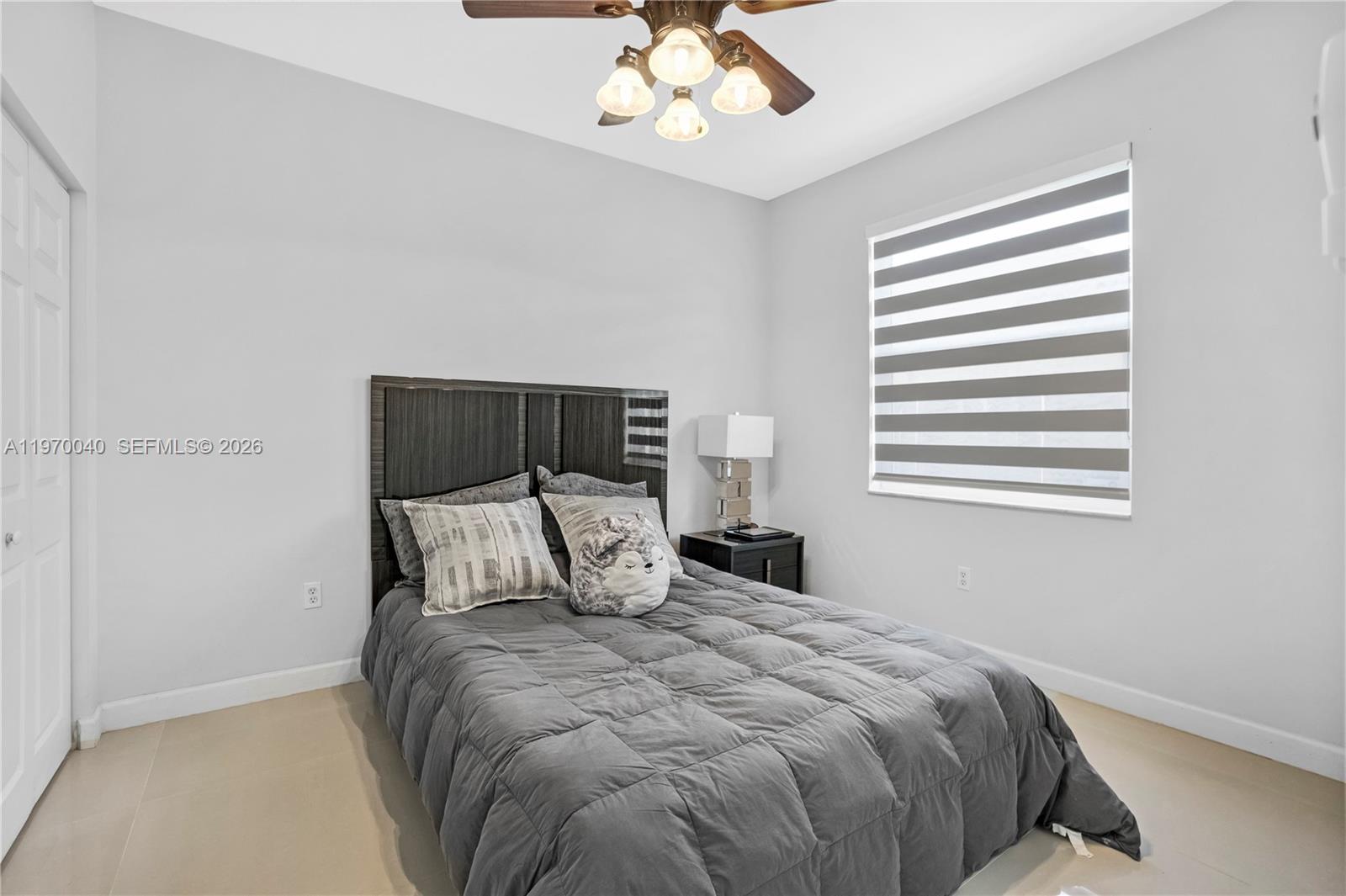 2132 Northeast 38th Road Homestead, FL 33033 - Photo 18 of 48 a bedroom with a large bed and a chandelier