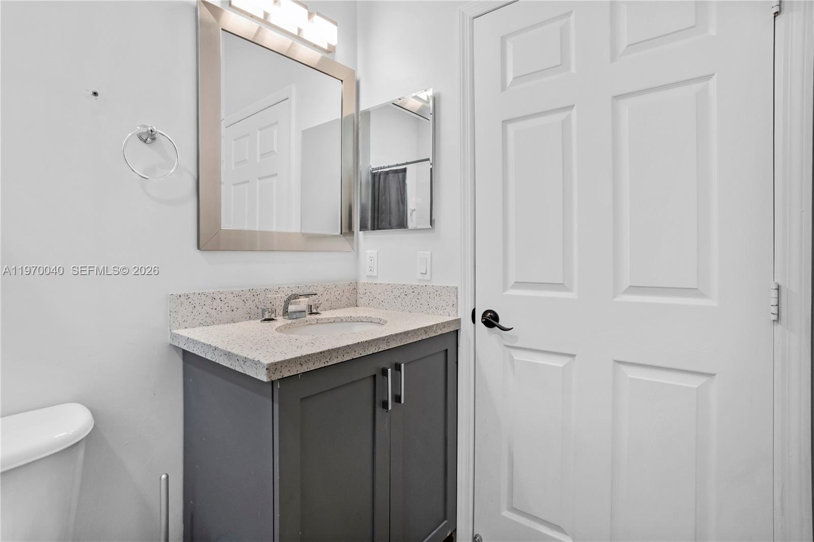 2132 Northeast 38th Road Homestead, FL 33033 - Photo 20 of 48 a bathroom with a sink and mirror with toilet