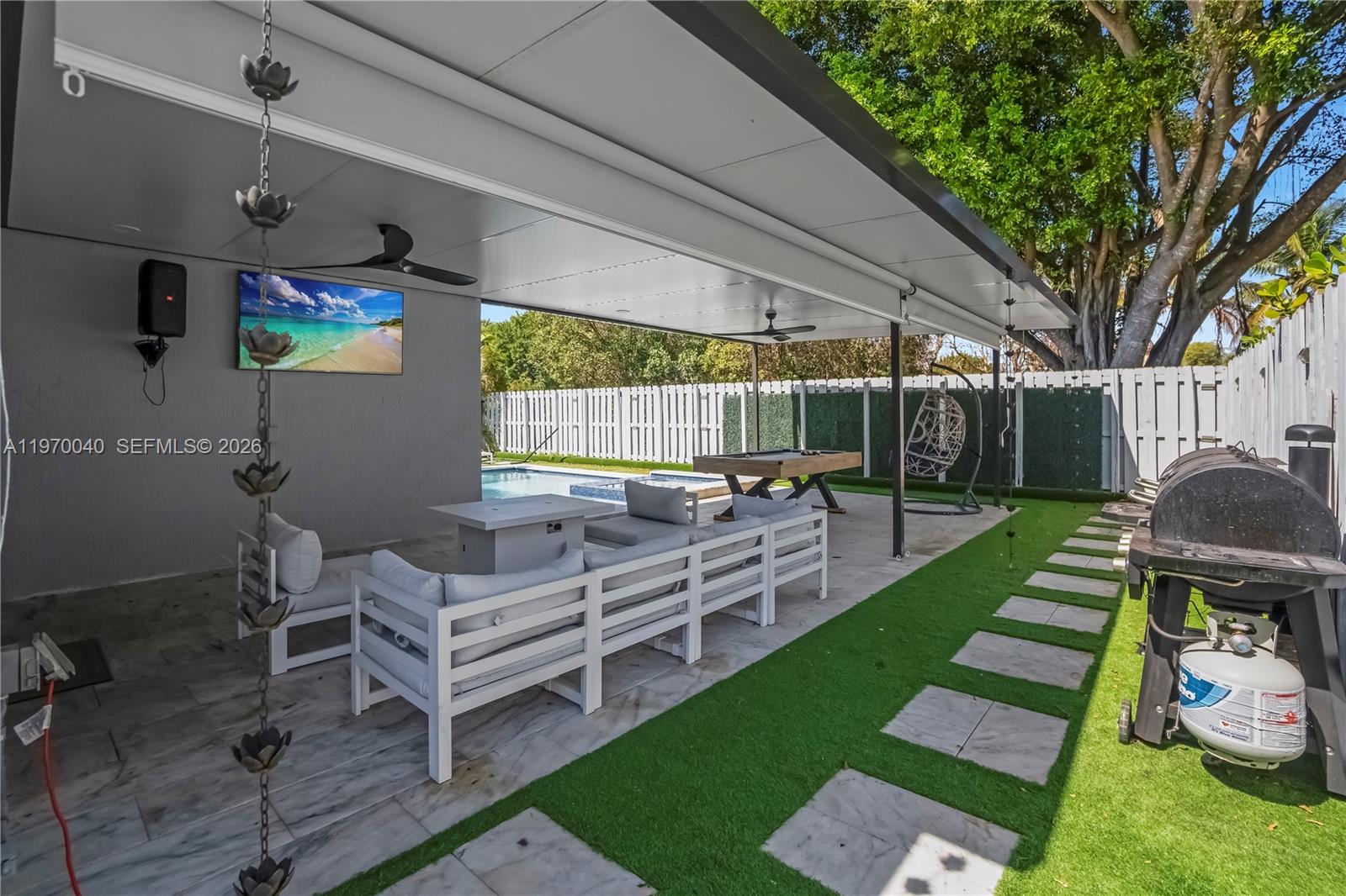 2132 Northeast 38th Road Homestead, FL 33033 - Photo 30 of 48 a view of a backyard with furniture and a garden