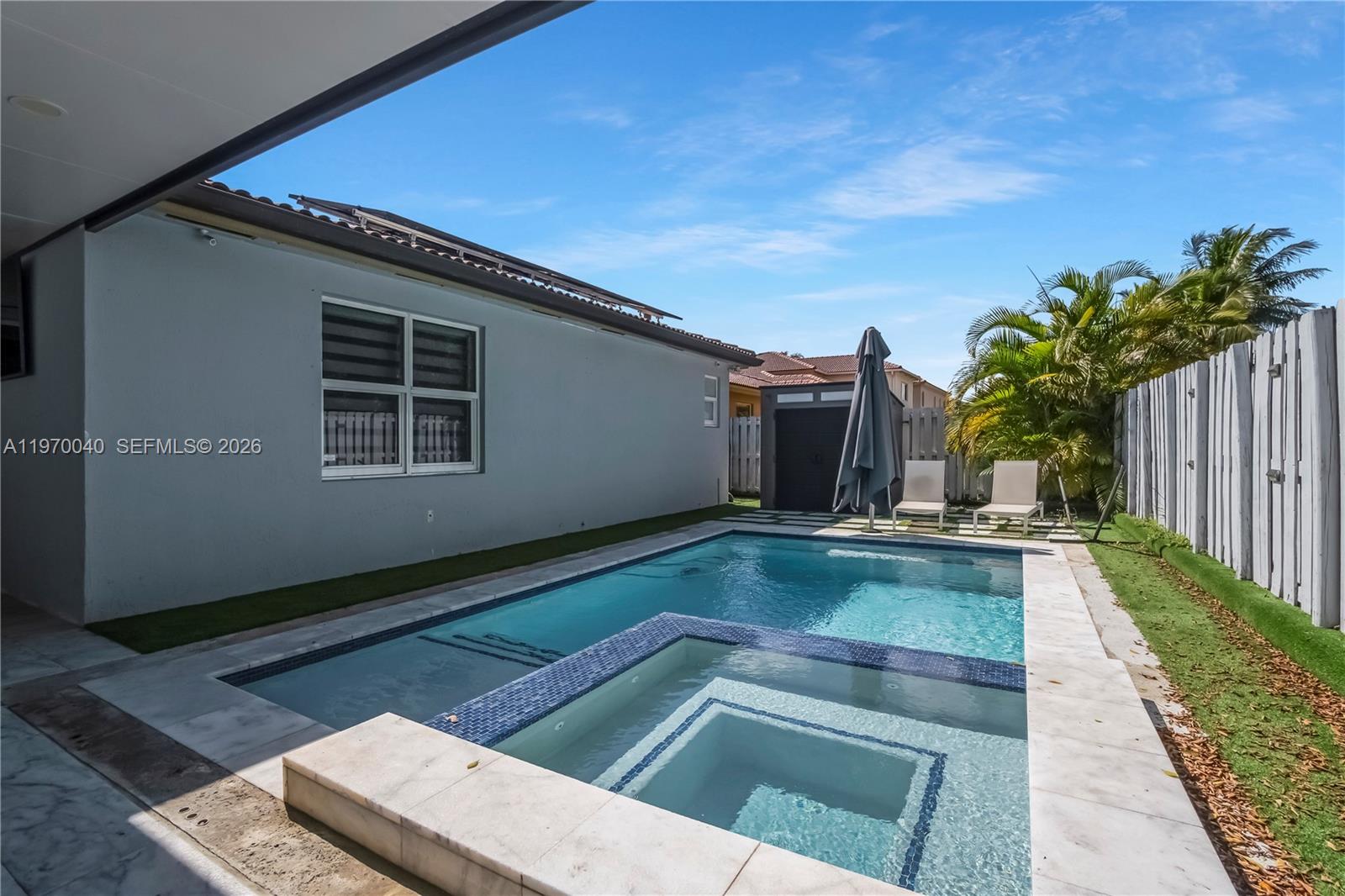 2132 Northeast 38th Road Homestead, FL 33033 - Photo 33 of 48 a view of backyard with swimming pool and outdoor seating