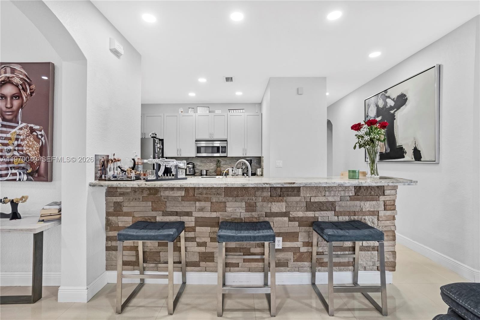 2132 Northeast 38th Road Homestead, FL 33033 - Photo 6 of 48 a kitchen with cabinets and chairs