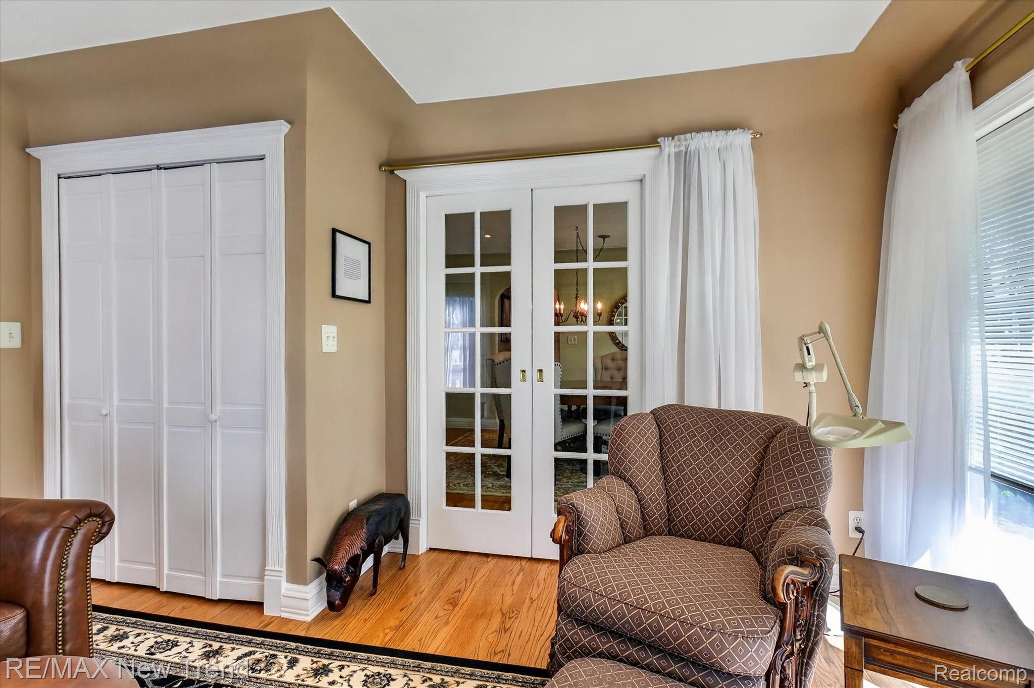2529 South Commerce Road Walled Lake, MI 48390 - Photo 16 of 66 Wood-finish flooring, white bi-fold closet doors, French doors with glass panes, and ample natural light
