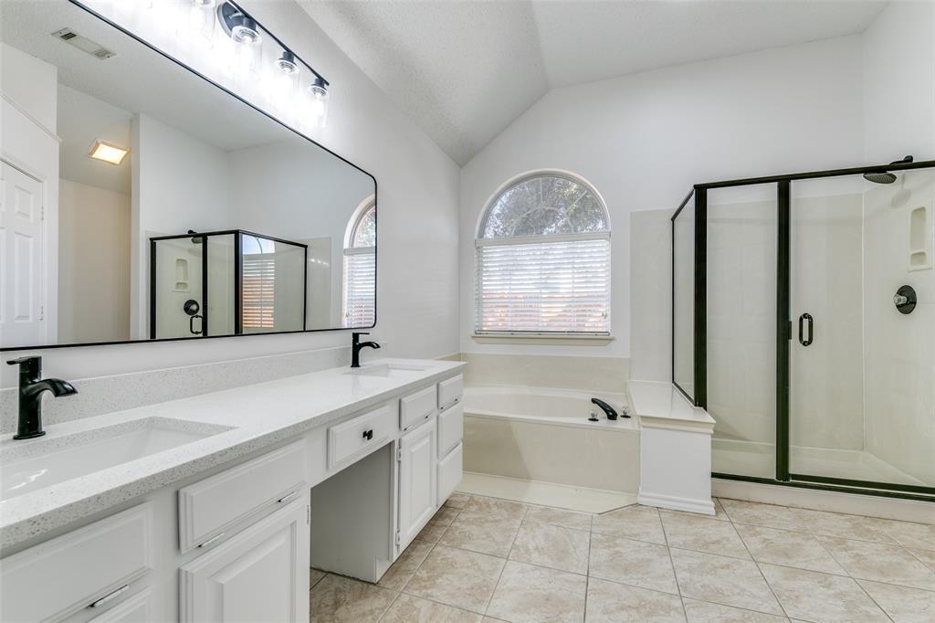 1913 Smith Drive Plano, TX 75023 - Photo 11 of 12 a spacious bathroom with a double vanity sink a mirror and a bathtub