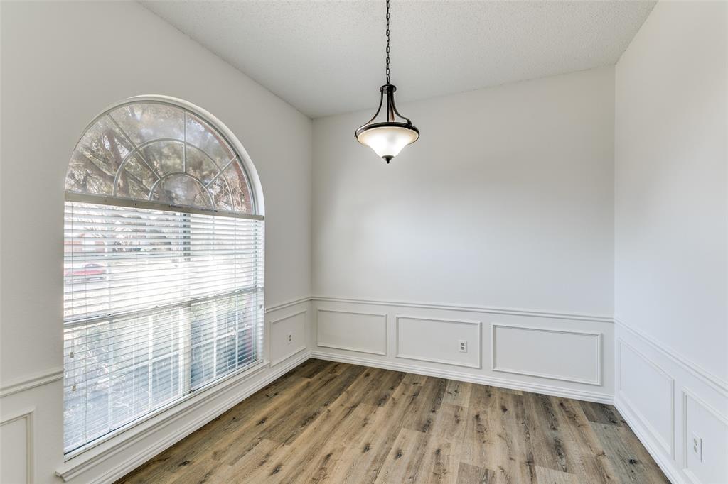 1913 Smith Drive Plano, TX 75023 - Photo 4 of 12 a view of an empty room with wooden floor and a window