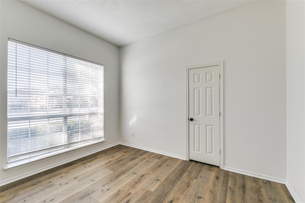 1913 Smith Drive Plano, TX 75023 - Photo 6 of 12 a view of an empty room with wooden floor and a window