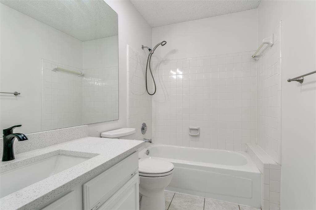 1913 Smith Drive Plano, TX 75023 - Photo 8 of 12 a bathroom with a granite countertop sink a toilet and shower