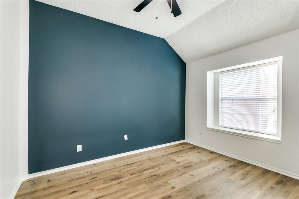 1913 Smith Drive Plano, TX 75023 - Photo 10 of 12 an empty room with a window and a ceiling fan