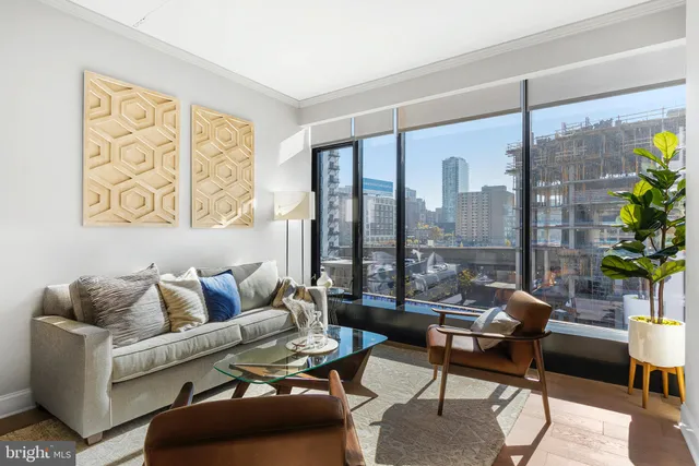 a living room with furniture and a floor to ceiling window