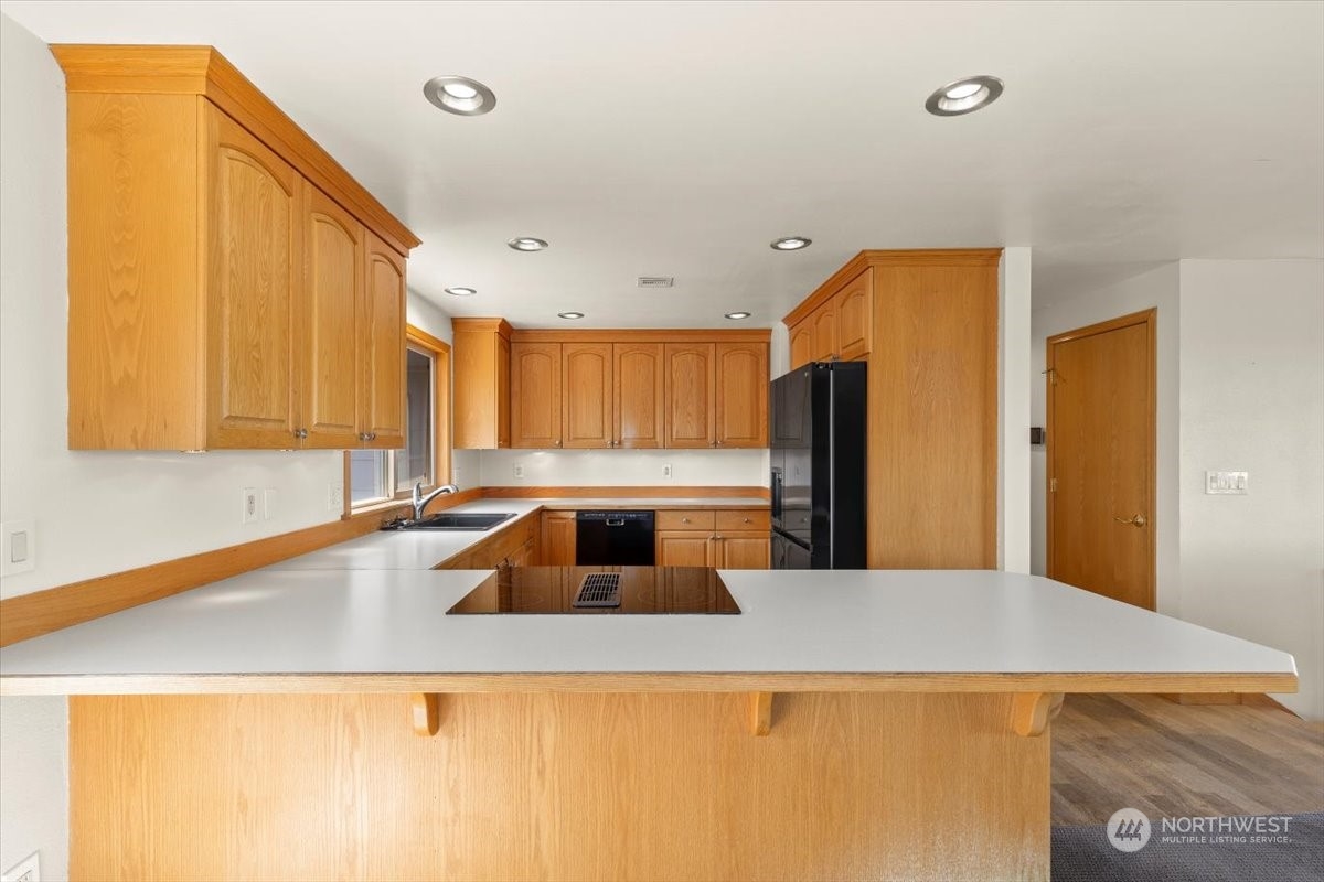 120 Echo Glen Place Yakima, WA 98908 - Photo 12 of 40 a kitchen with a sink a counter top space and stainless steel appliances