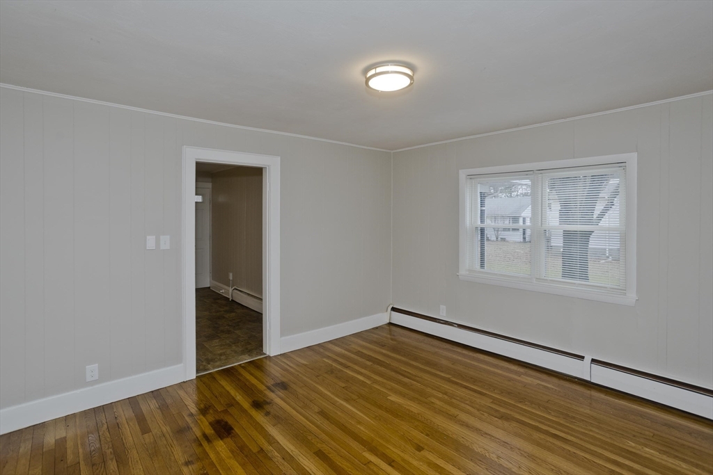 177 Marion Street Chicopee, MA 01013 - Photo 22 of 36 a view of empty room with wooden floor and fan