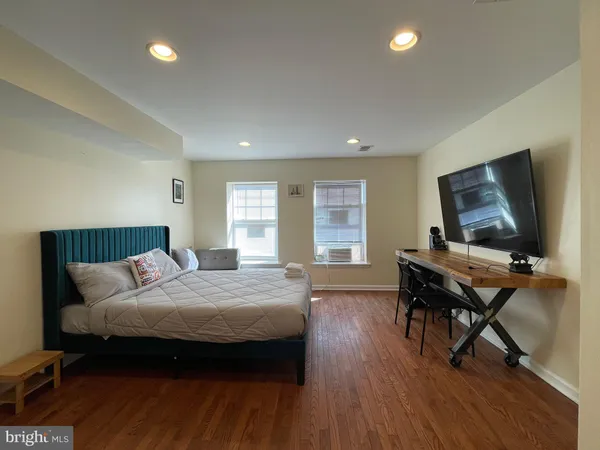 a view of a refrigerator in kitchen and an empty room