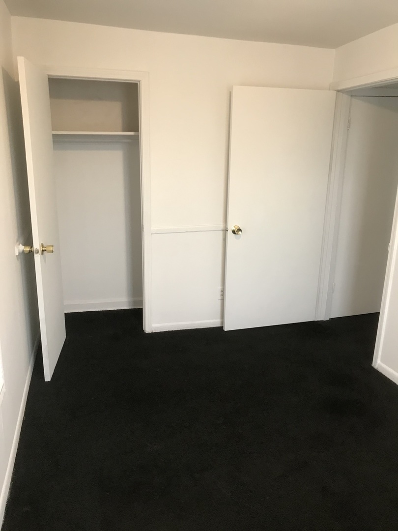 3929 Main Street, Unit 2 McHenry, IL 60050 - Photo 14 of 17 an empty room with wooden floor