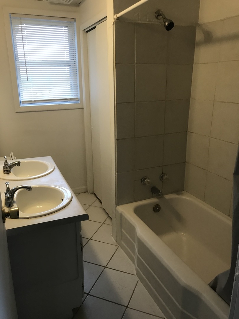 3929 Main Street, Unit 2 McHenry, IL 60050 - Photo 16 of 17 a bathroom with a sink and a bathtub